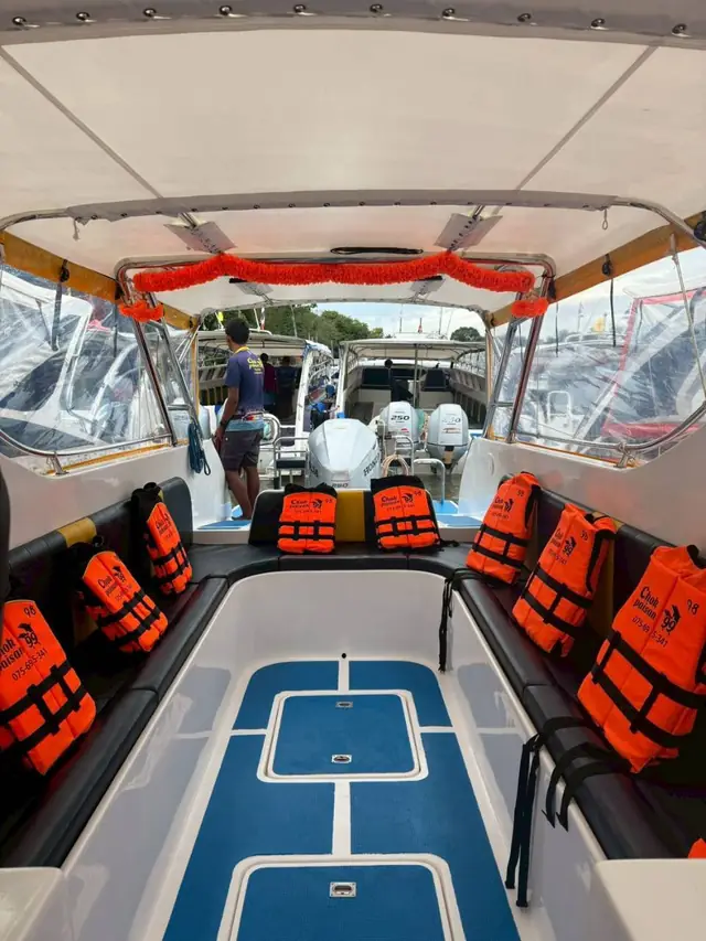 Inside the speedboat, life jackets at every seat