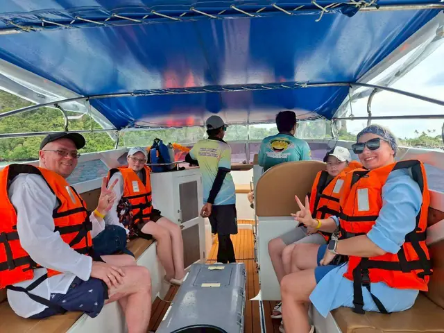 Travellers in life jackets on the speedboat