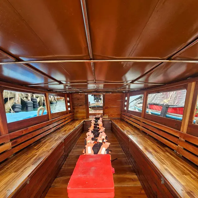 Inside a longtail, wooden benches on both sides