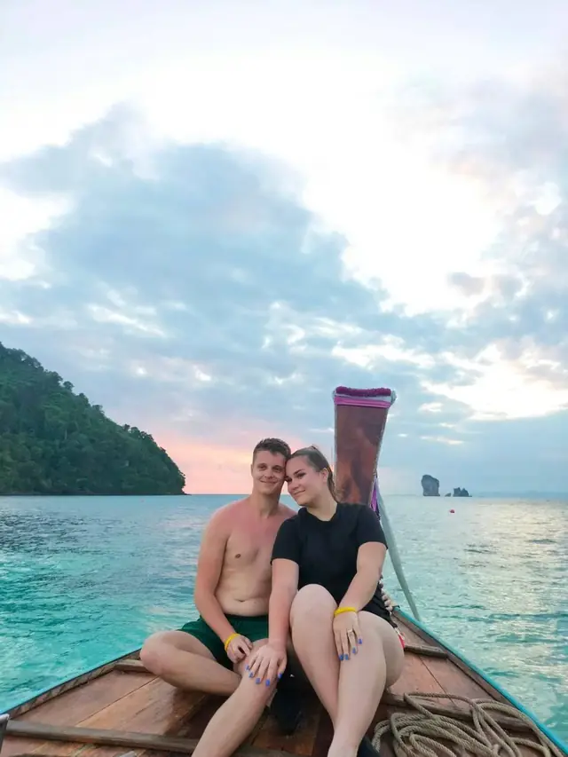 Couple on a longtail bow in the evening