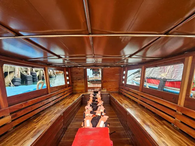 Inside a longtail, wooden benches on both sides