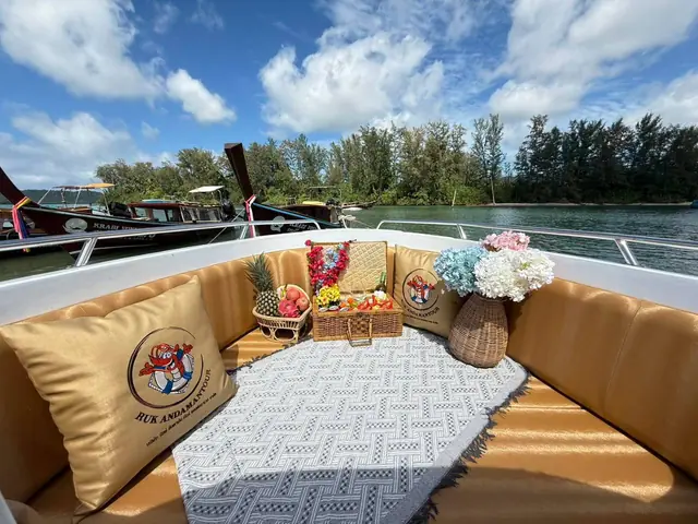 Speedboat bow with cushions, a mat, fruit and flowers